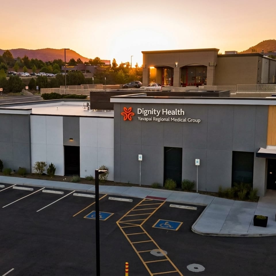 Dignity Health Yavapai Regional Medical Group building at sunset with mountains in the background.